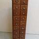 Antique oak apothecary cabinet with drawers