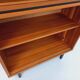 Vintage wooden bookshelf in teak style from the 1960s.