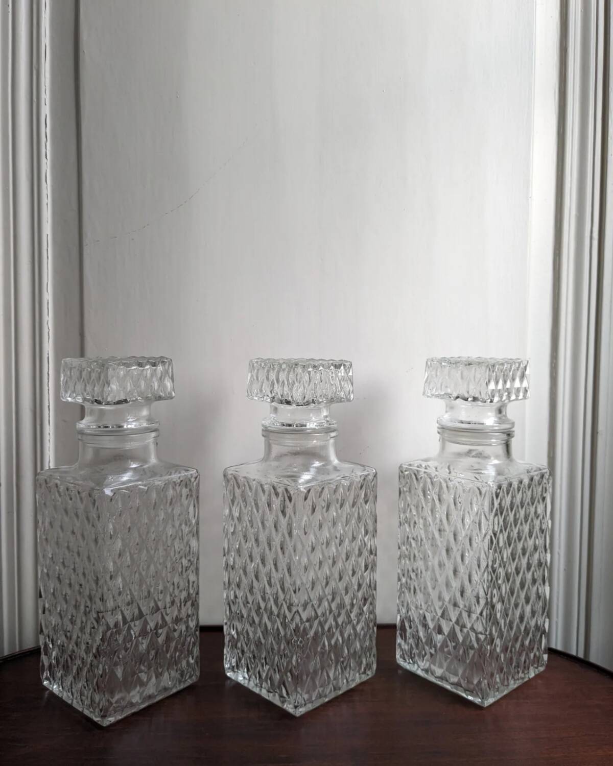 3 diamond-patterned chiseled glass carafes