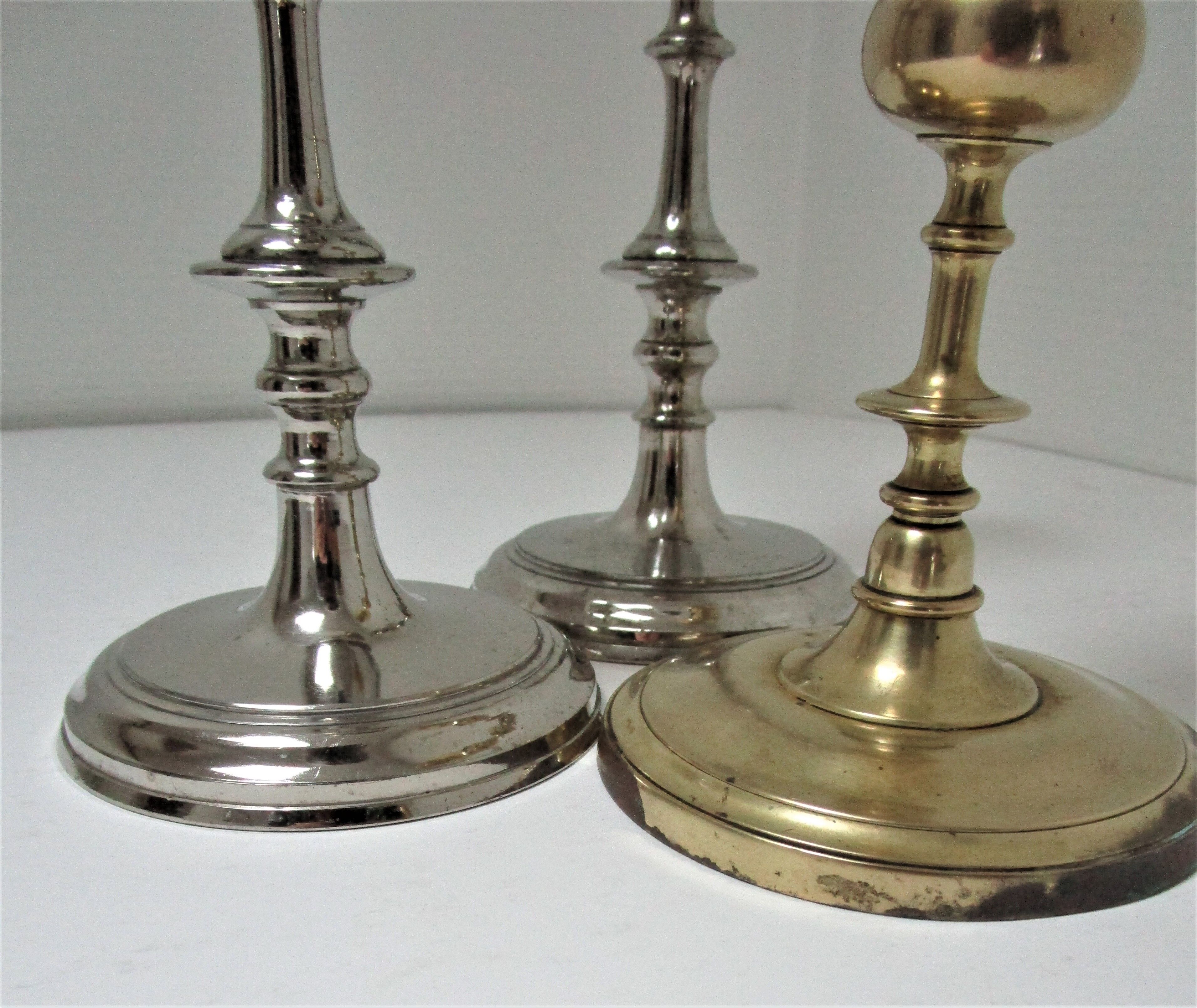 three brass and chrome candle holders early twentieth century