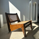 Reclined armchair in canned teak in natural wood