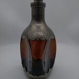 Vintage decanter in glass and tin.