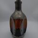 Vintage decanter in glass and tin.