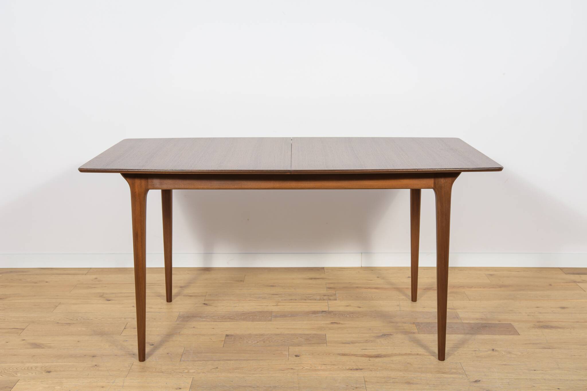 Extendable teak dining table in Mid-Century style from McIntosh, UK.