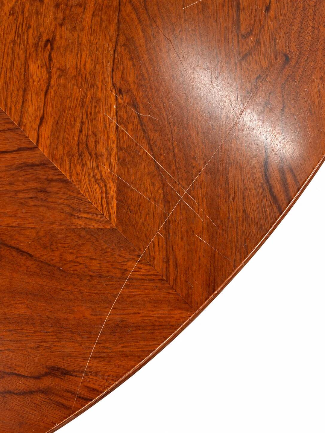 Large round dining table with black blade legs.