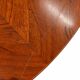 Large round dining table with black blade legs.