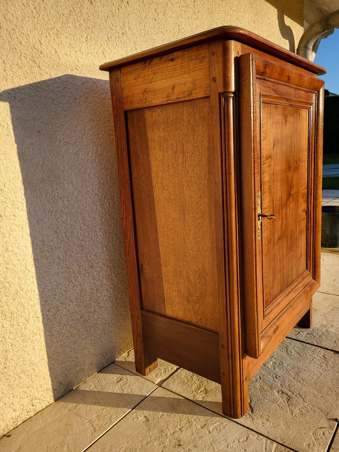 Furniture with a cherry wood door.