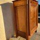 Furniture with a cherry wood door.