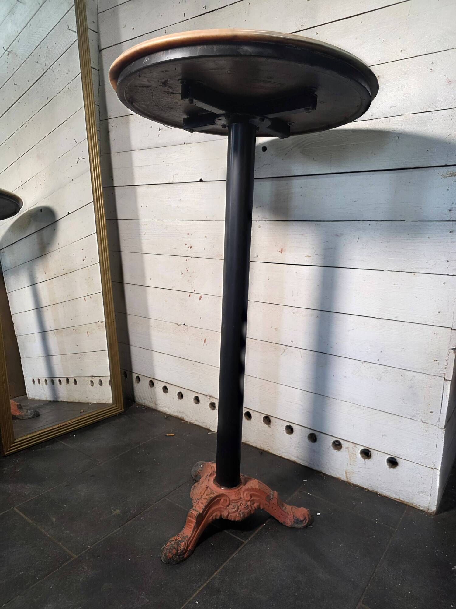 Bistro standing table with marble top and cast iron base.