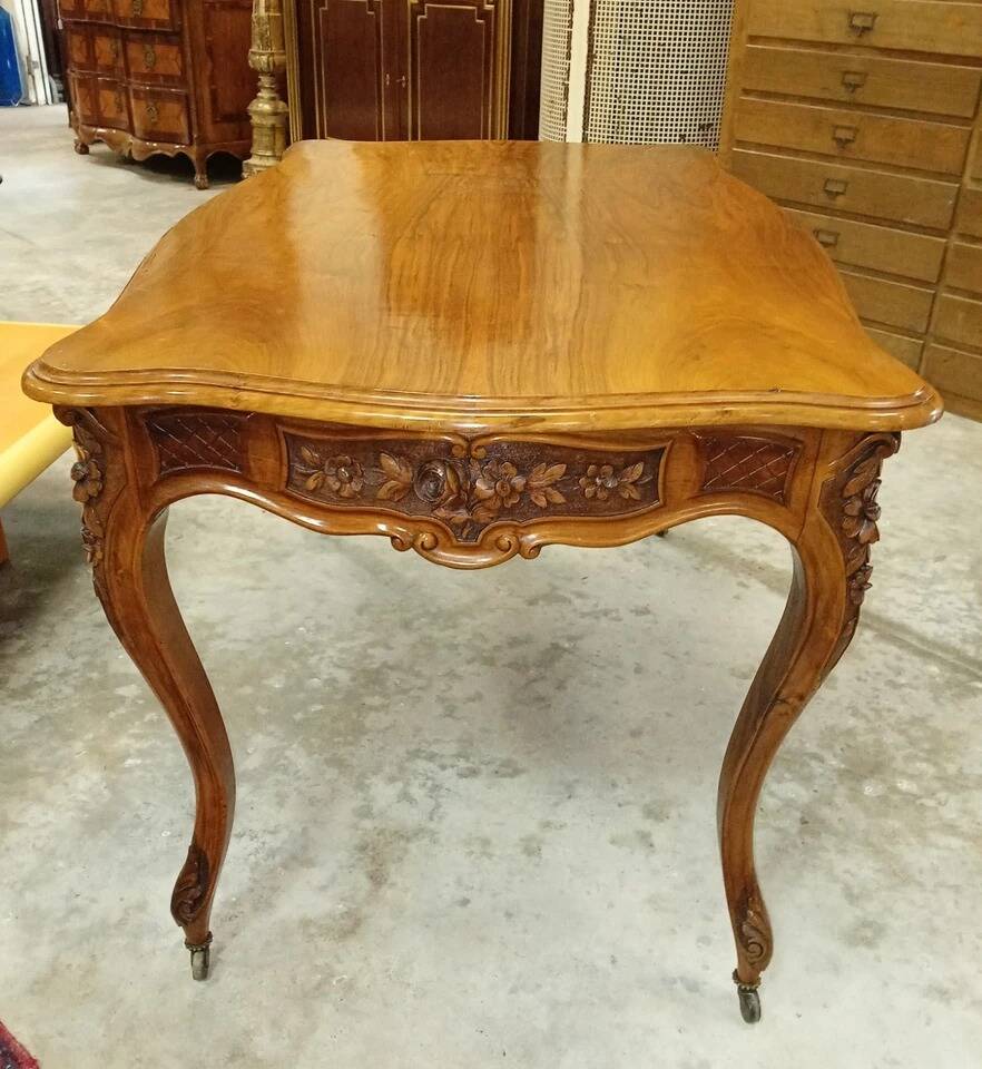 Curved desk in Louis XV style, made of carved and moulded walnut.