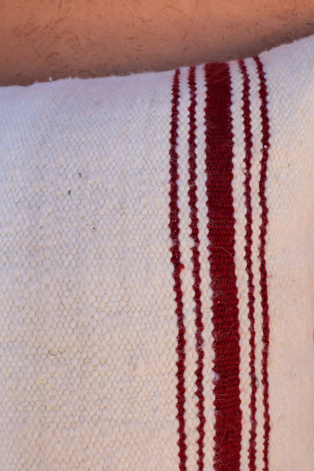 burgundy and white striped cushion in handmade wool