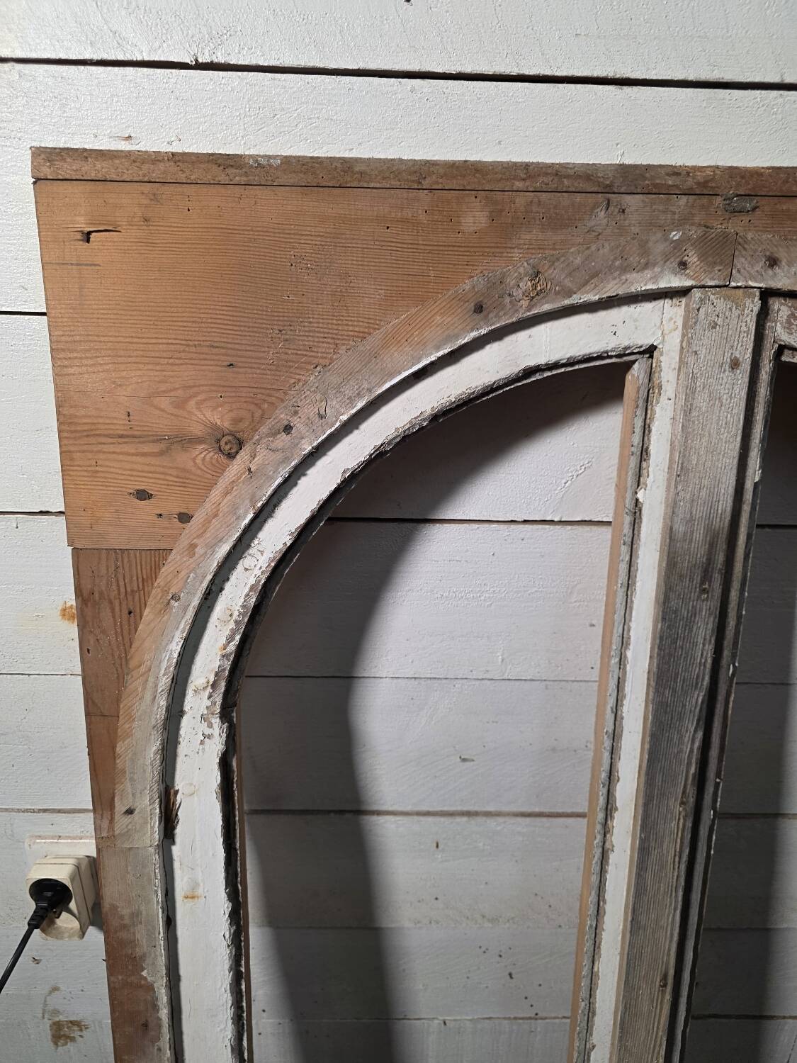 Old arched window made of fir wood