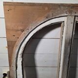 Old arched window made of fir wood