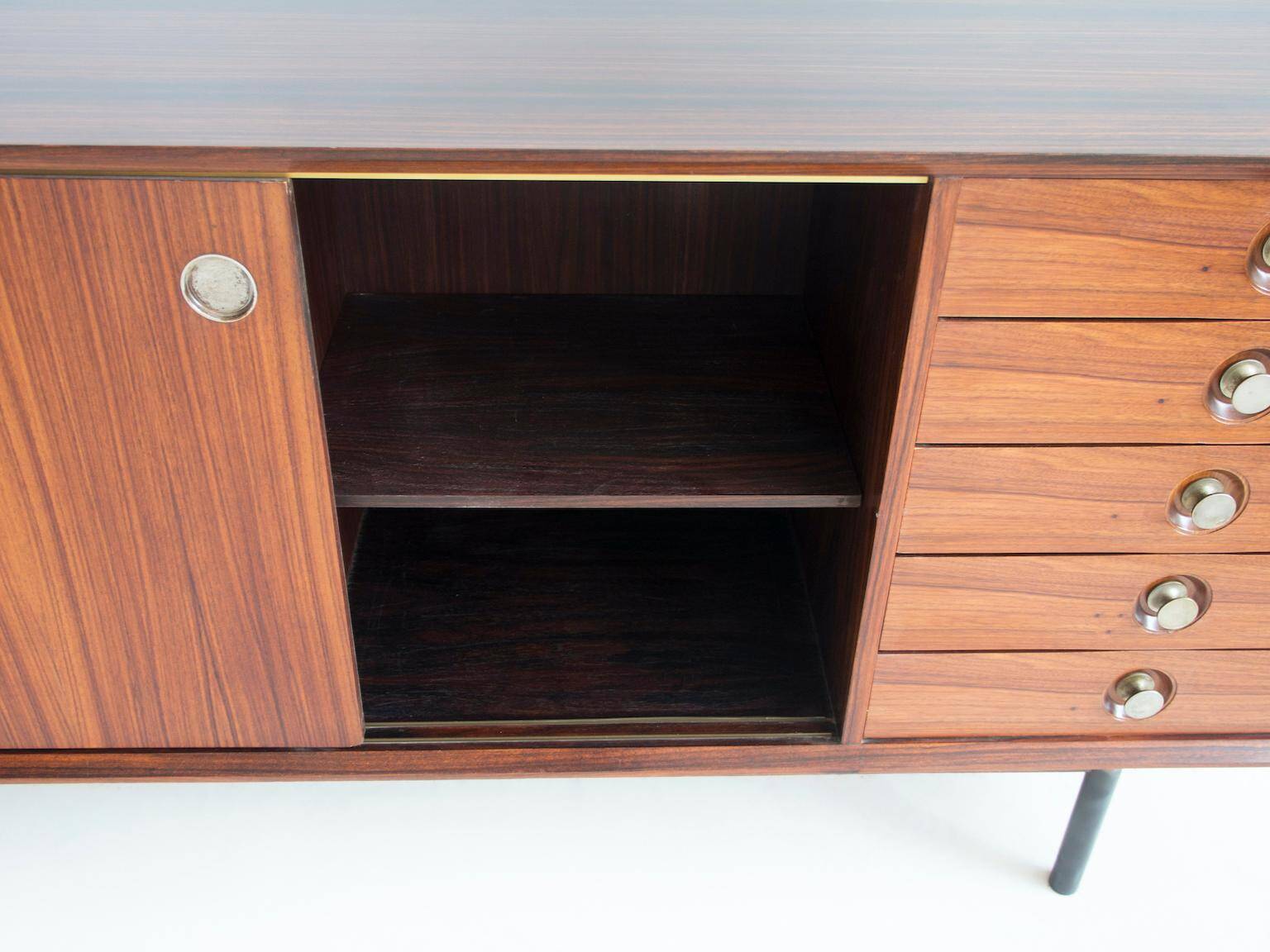 Wooden sideboard with sliding door and white drawers, around 1960.