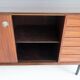 Wooden sideboard with sliding door and white drawers, around 1960.