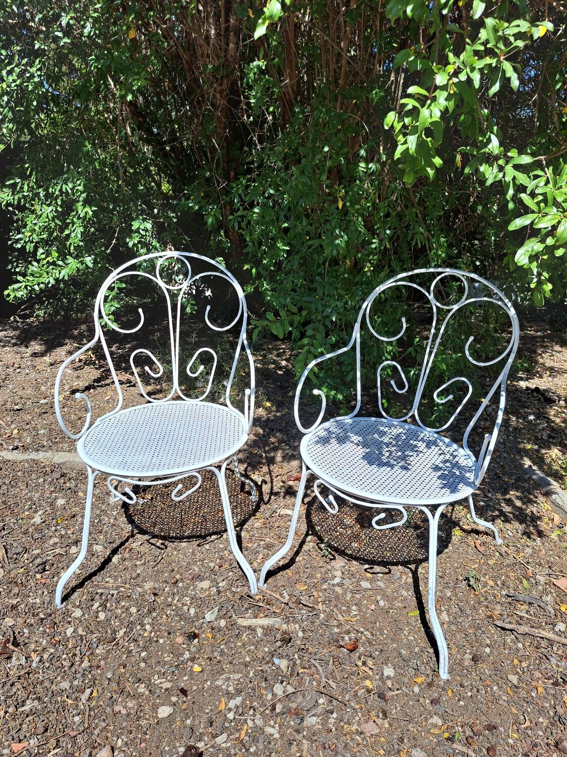 Pair of old white iron armchairs