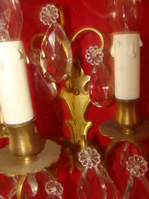Pair of bronze and crystal wall lights with three candle holders from the early 20th century.