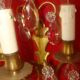 Pair of bronze and crystal wall lights with three candle holders from the early 20th century.