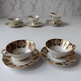 Set of mismatched fine porcelain cups signed with saucer