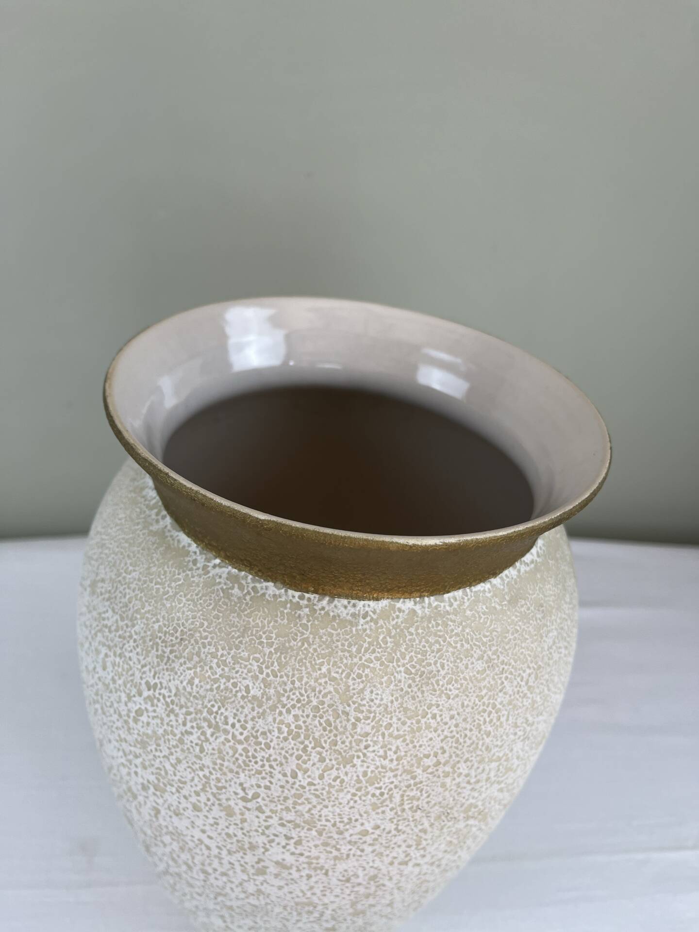 Cream speckled glazed vase with a gold rim, 1970s.