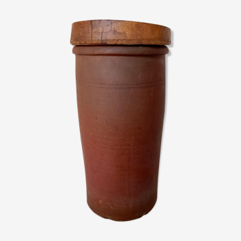 Old sandstone pot with wooden lid