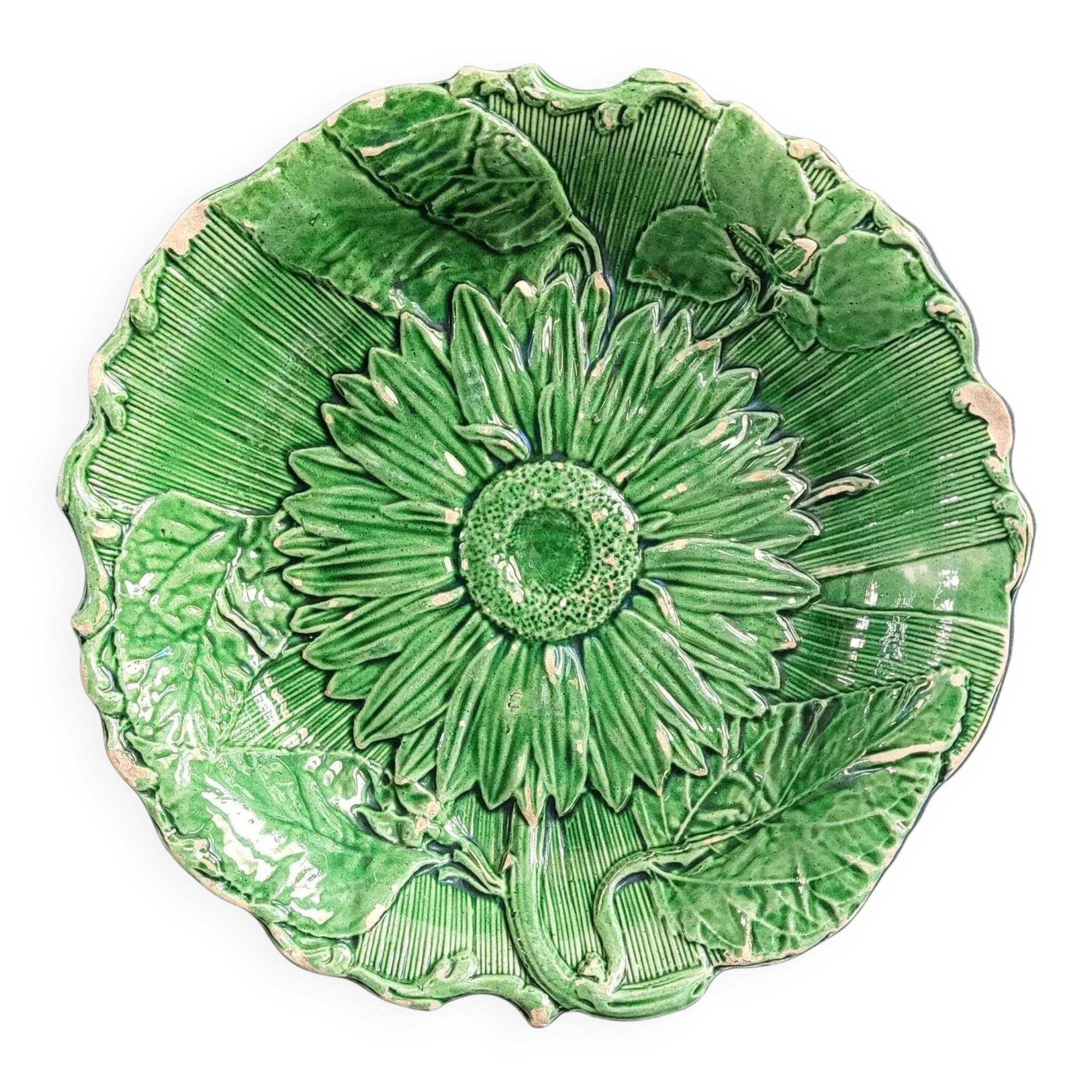 Plate decorated with a sunflower motif in slipware.