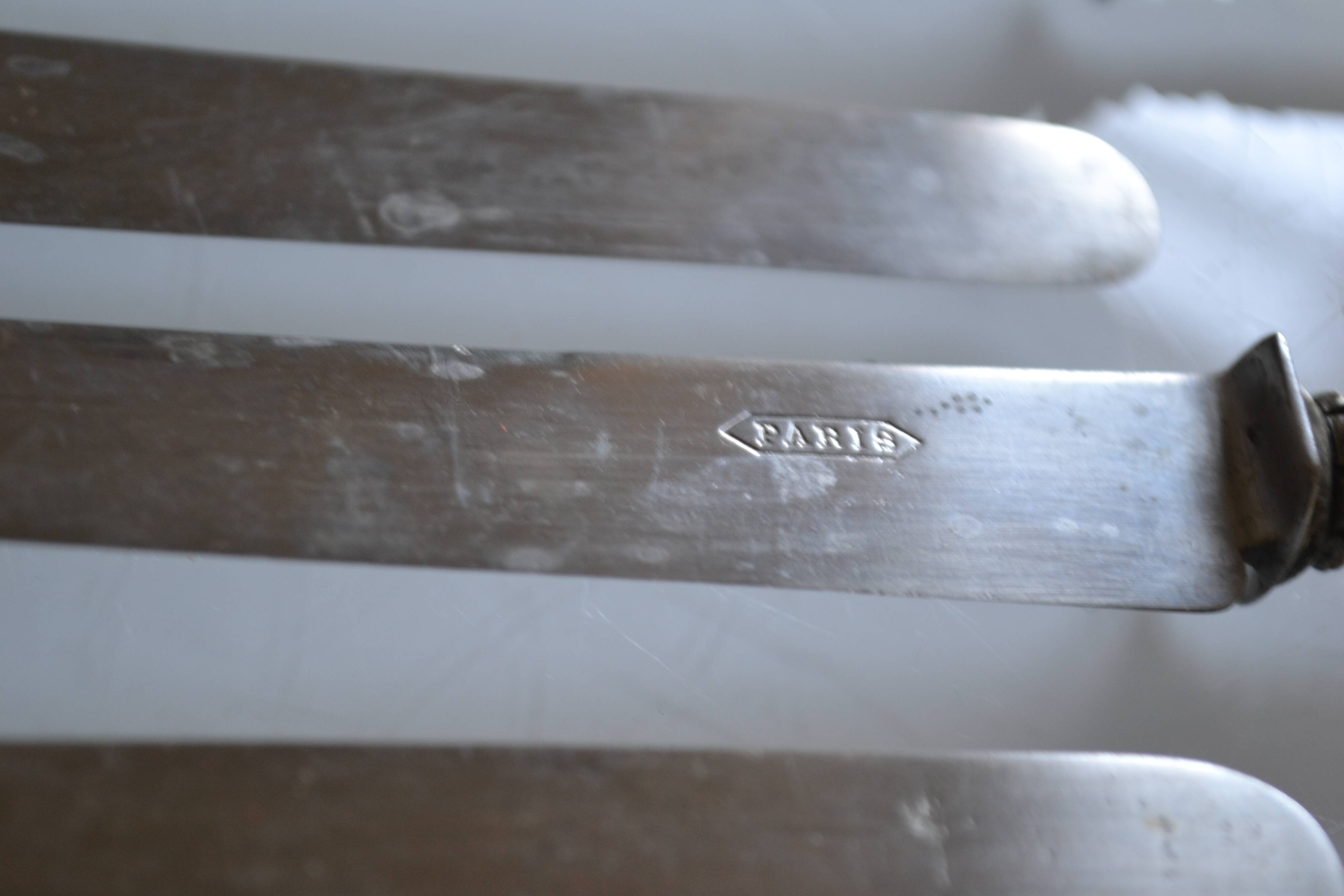 11 antique 19th-century table knives with ivory-colored monogram handles