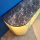 Vintage yellow sideboard, and black marble top.