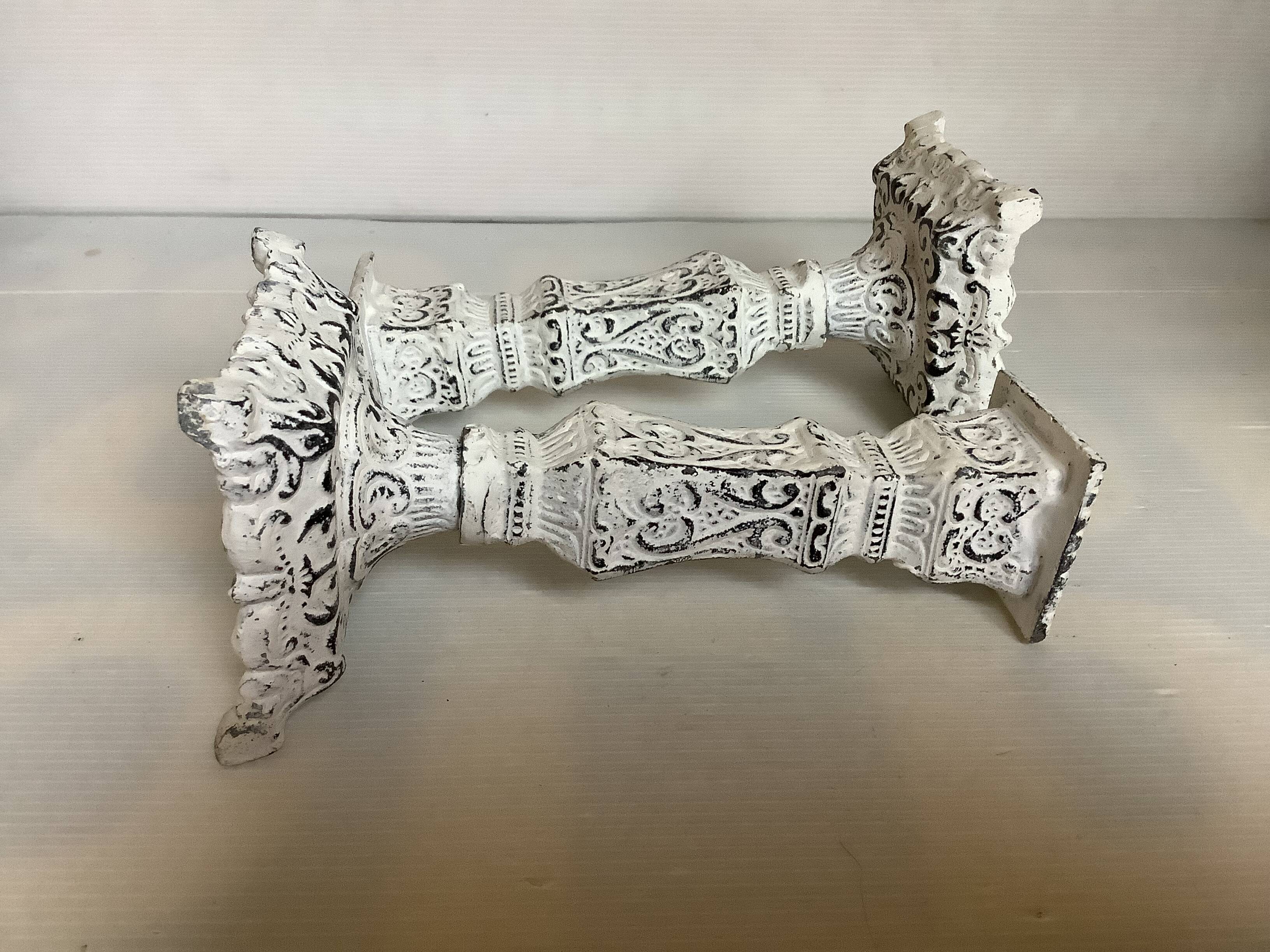 Pair of patinated cast iron candlesticks
