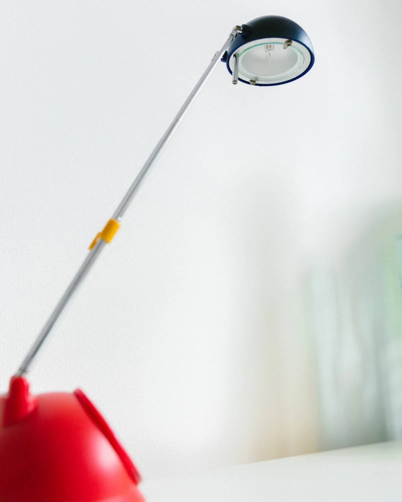 Blue-painted metal shade, chrome articulated arm desk lamp in Memphis-style 80s Pop Art with red base and yellow accents