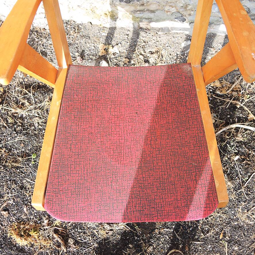 Old wooden and red leatherette bridge chair