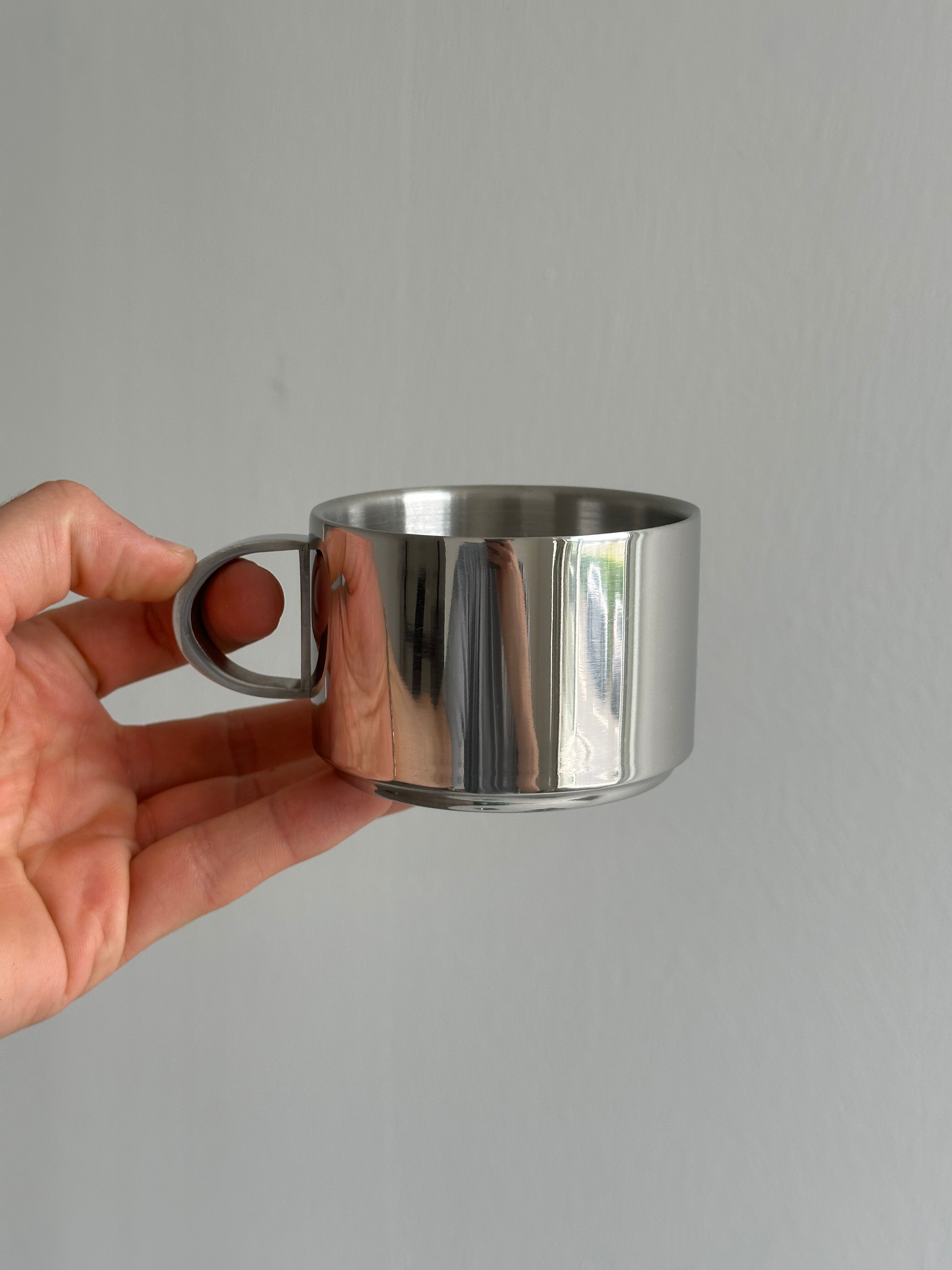 set of 4 stackable stainless steel coffee cups with saucers