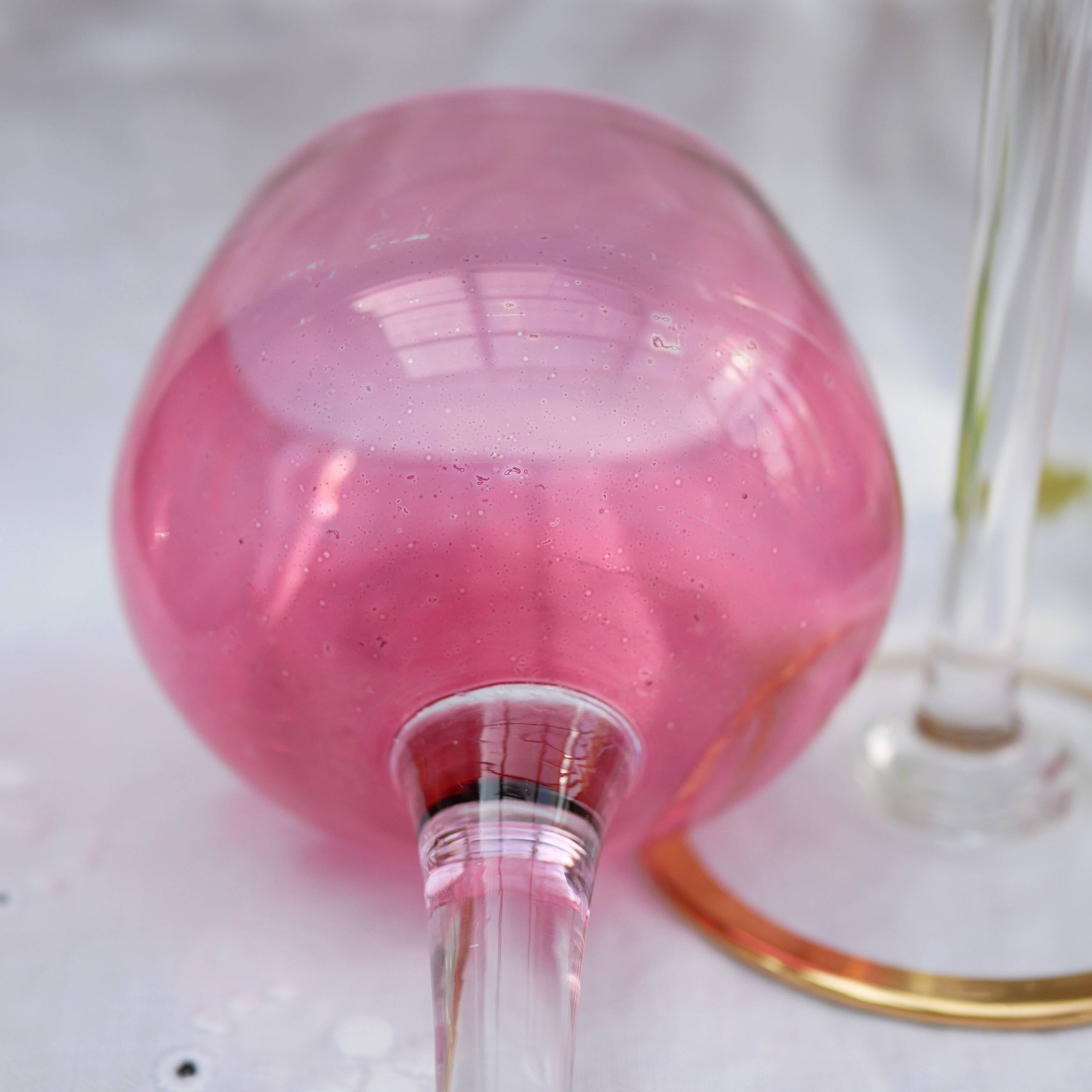 Four colorful stemmed wine glasses