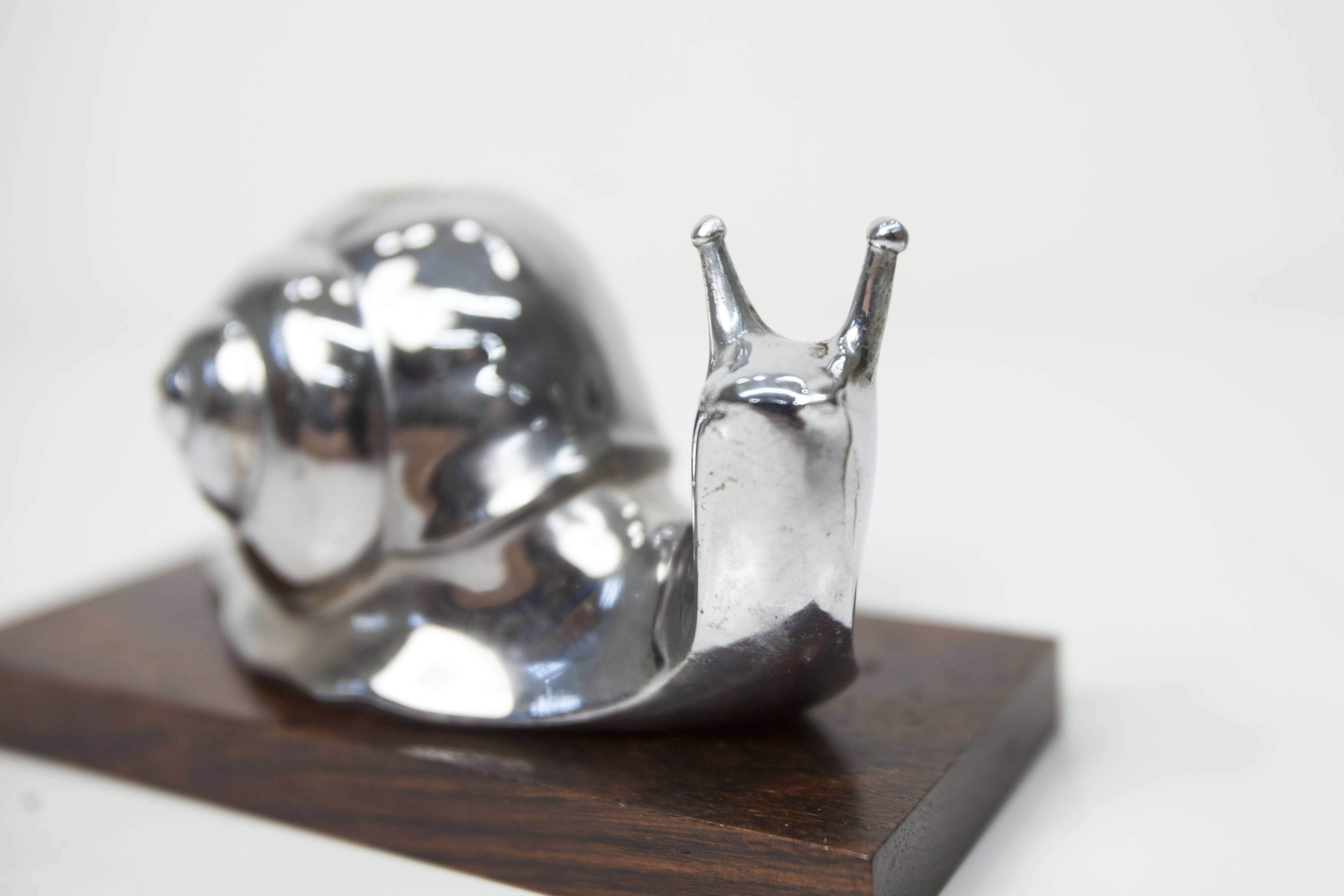 Silver snail candlestick on a teak base 1960