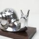 Silver snail candlestick on a teak base 1960