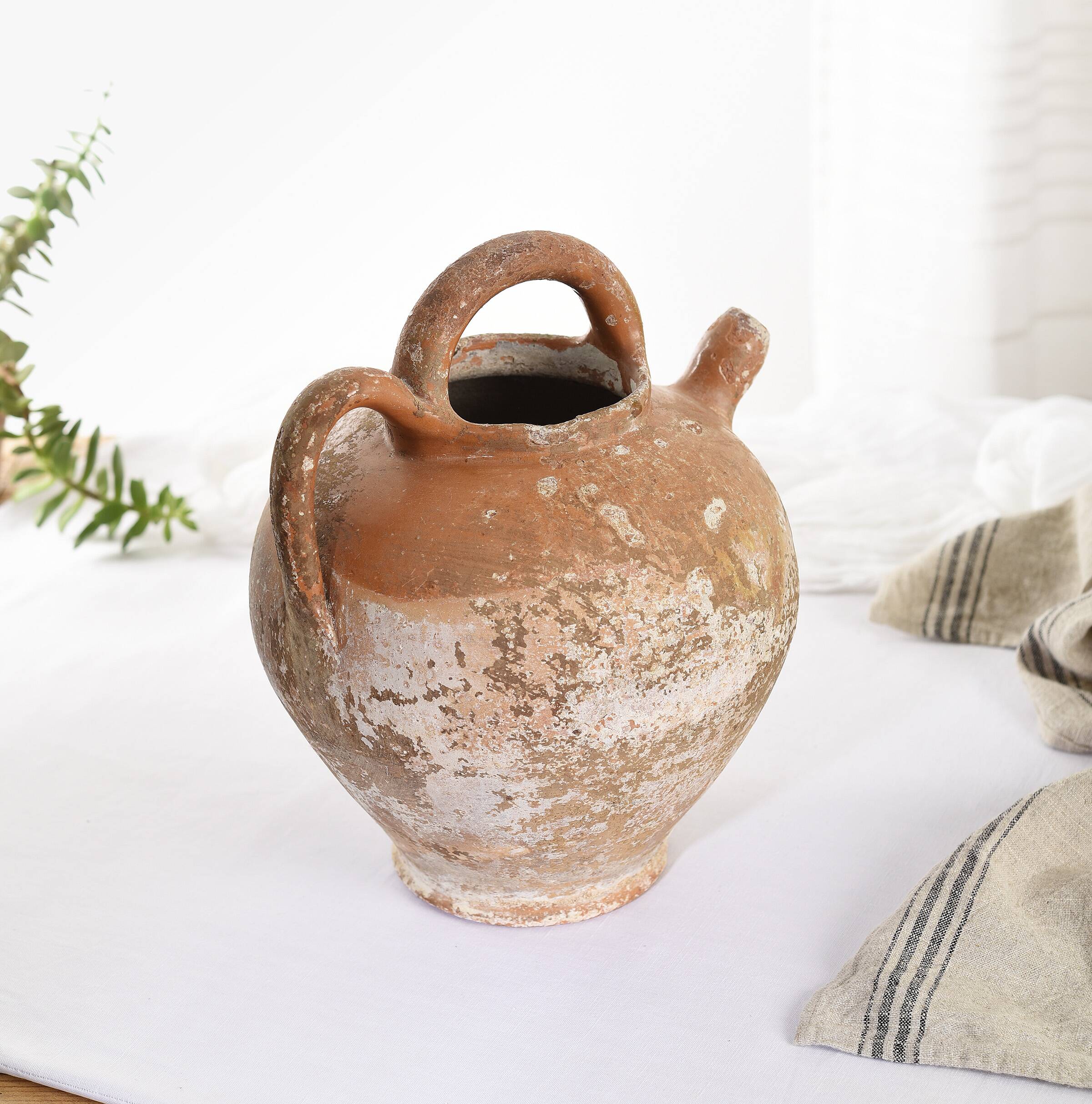 Old water jug. Gargoulette. Old terracotta pitcher.