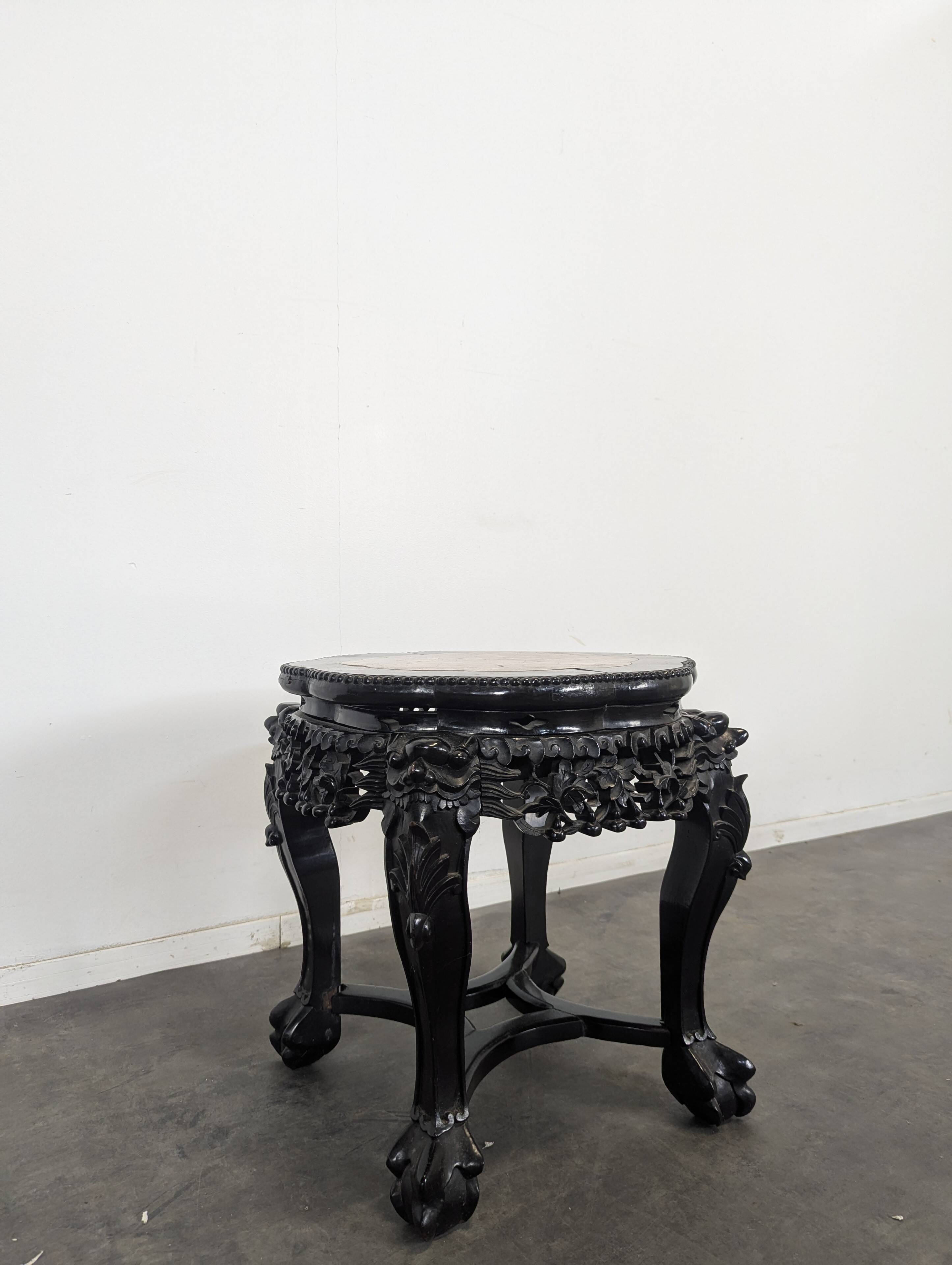 Side table with a wooden frame and marble top.