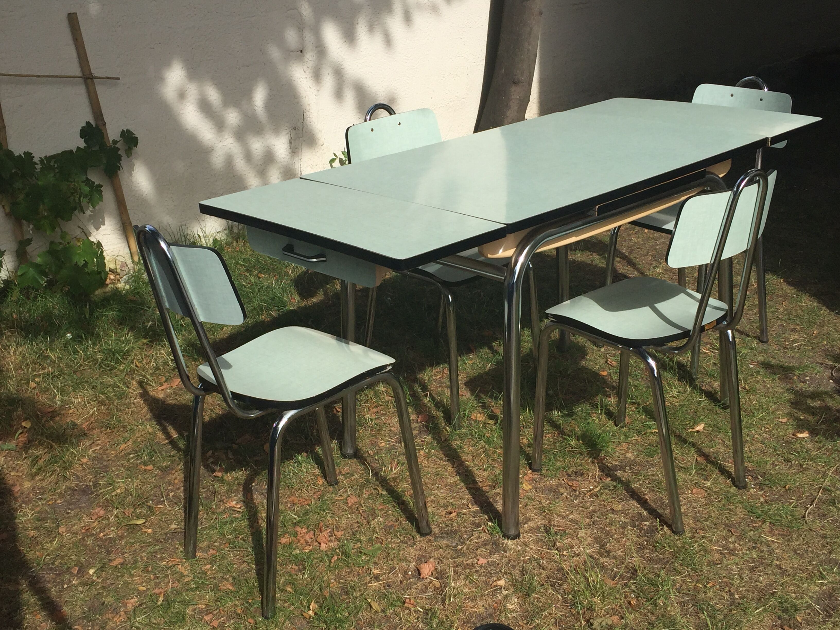Table and 4 green water formica chairs 60's