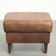 Set of a sheepskin armchair and ottoman finished with matching piping