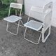 Set of three folding chairs with perforated metal.