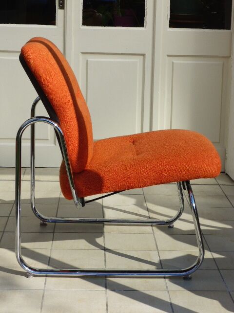 The 1970s orange armchair fabric and chrome metal