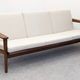 Living room, three-seater sofa and two armchairs, modernist in teak, France around 1950.