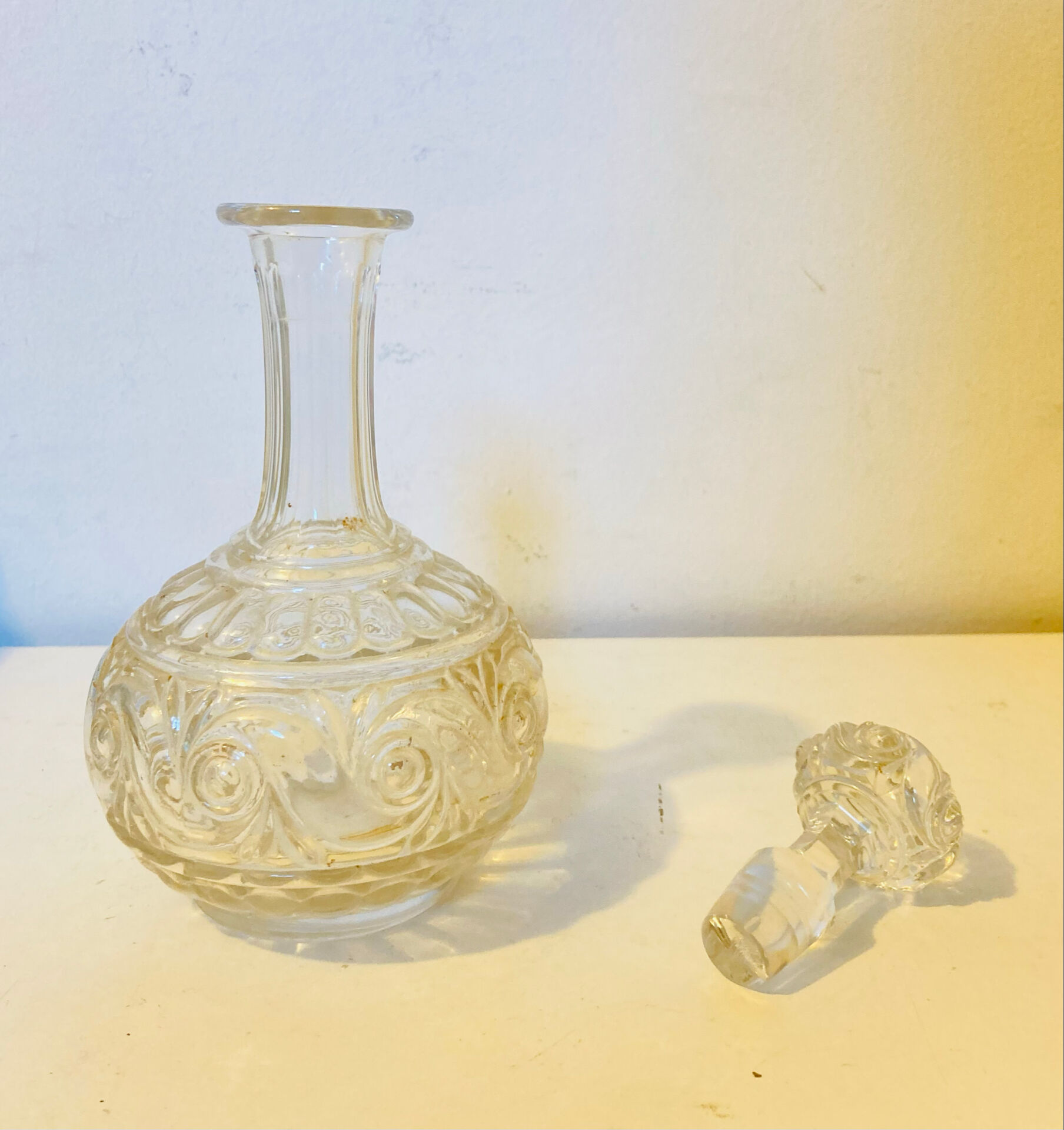 19th-century liqueur carafe in glass adorned with relief patterns.