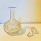 19th-century liqueur carafe in glass adorned with relief patterns.