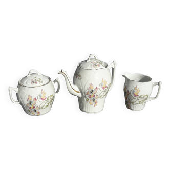 Set of a coffee maker, a sugar bowl and a porcelain creamer