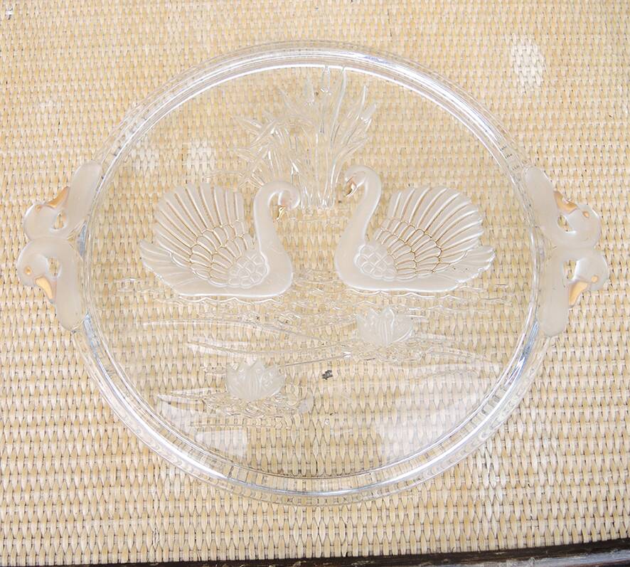 Vintage glass cake stand with swan decoration.
