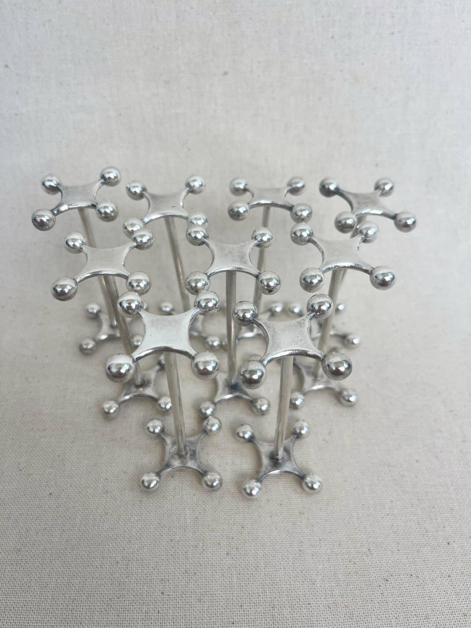 series of brutalist and sculptural silver-plated knife rests