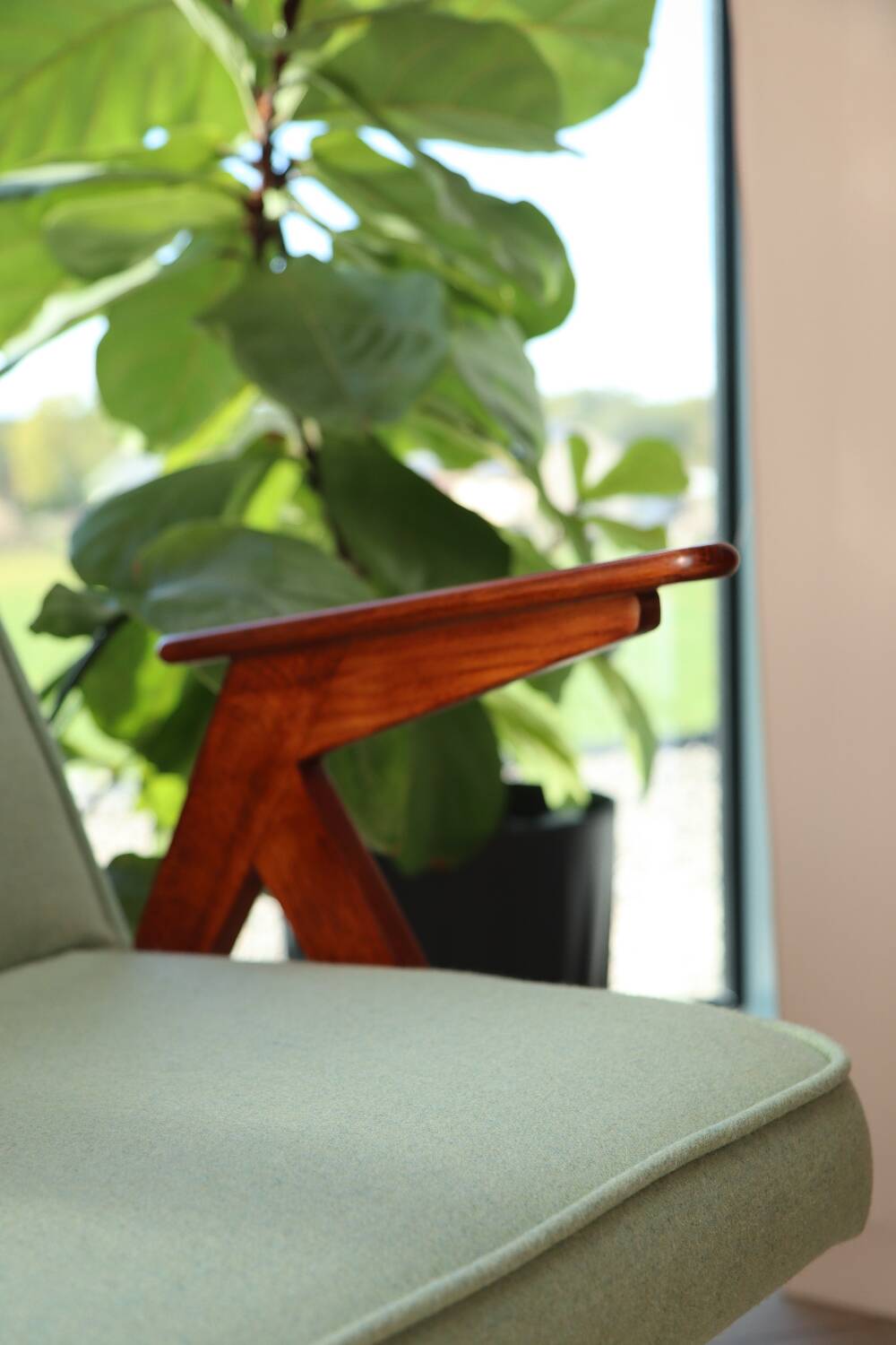 Vintage armchair in mint green wool, mid-century modern design.