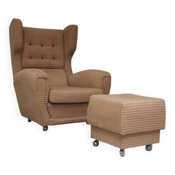 Beige wingback armchair and TVAR footrest, former Czechoslovakia.