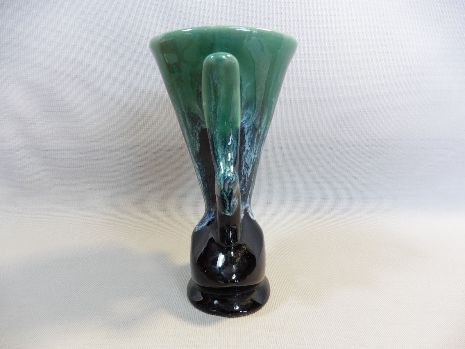 Praticality black and green vase numbered 666